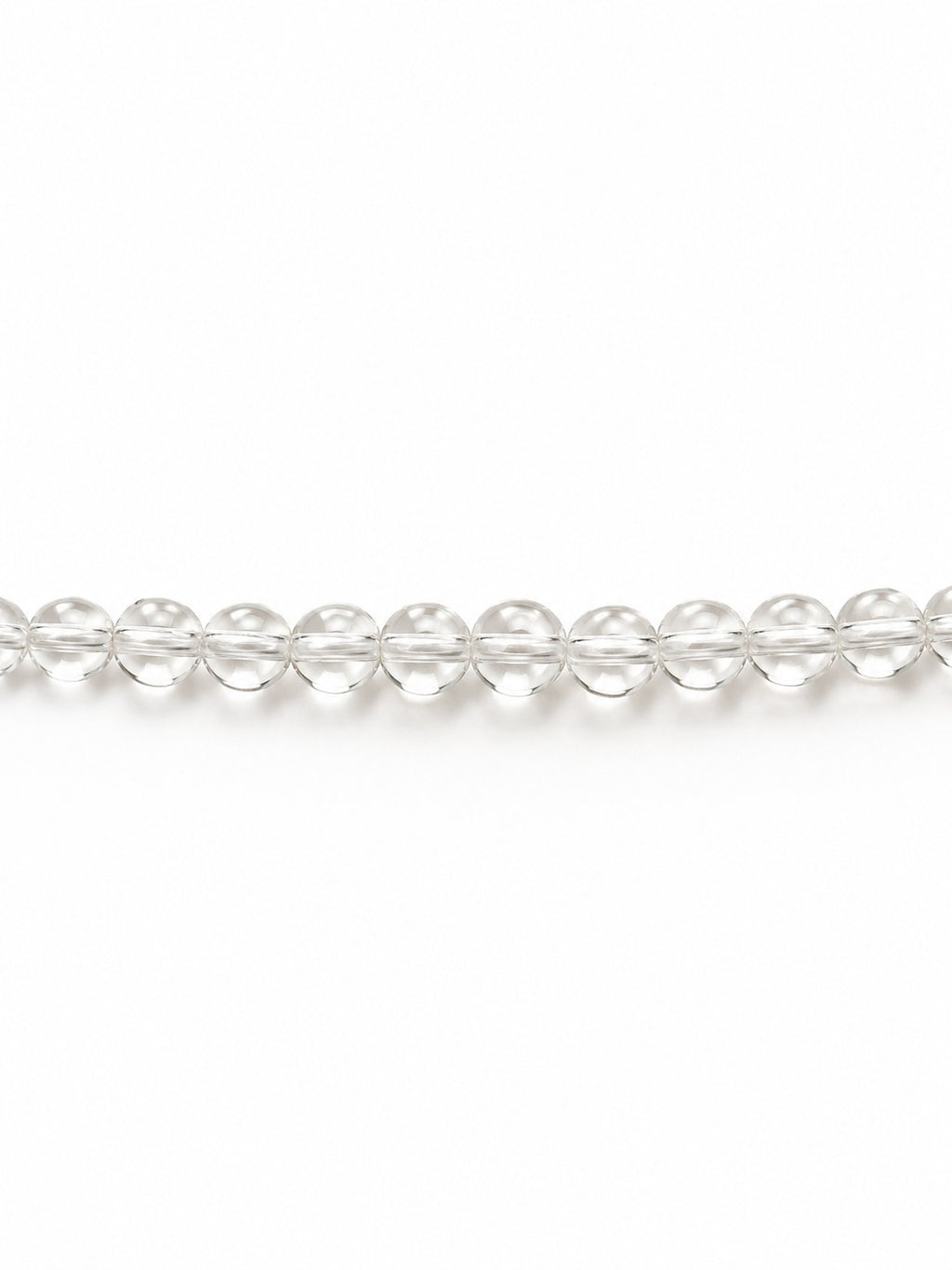 Clear handblown glass beads on white background
