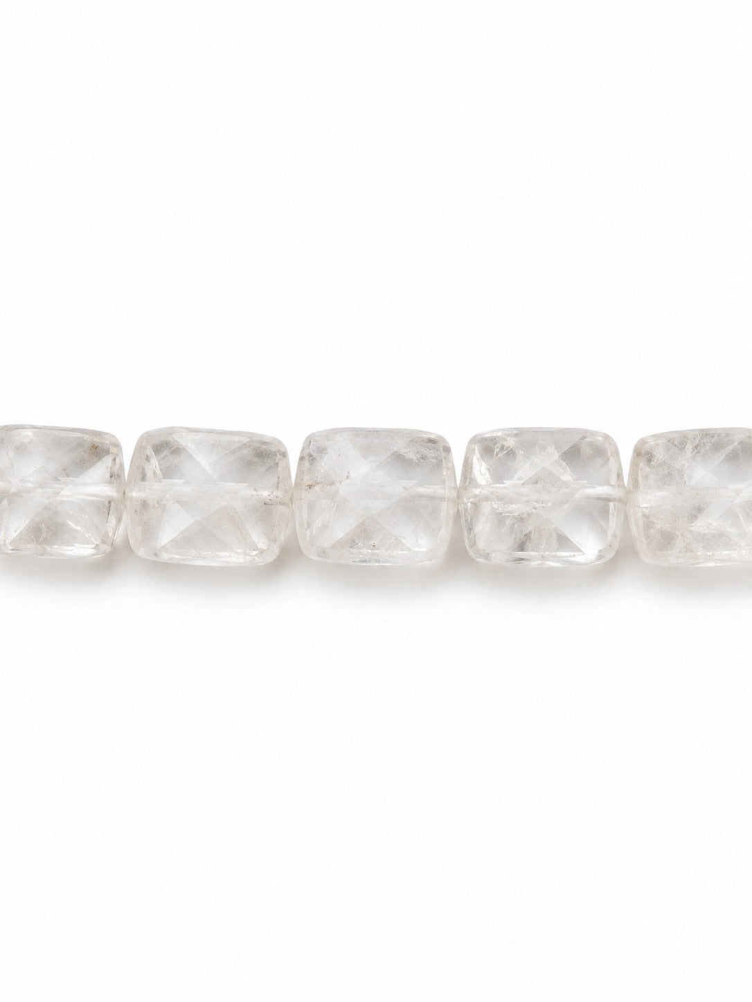 Clear quartz faceted square beads on white background