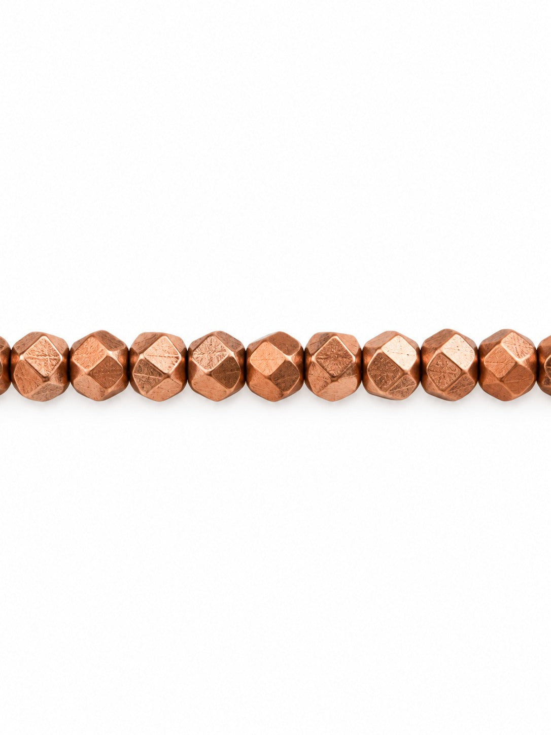 Copper faceted geo beads on white background