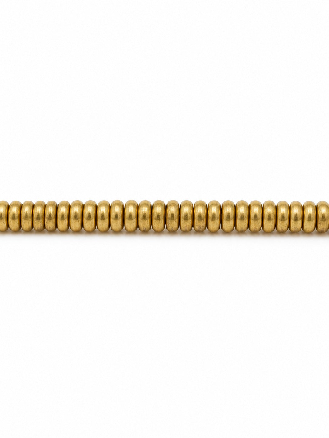 Gold donut beads on white background