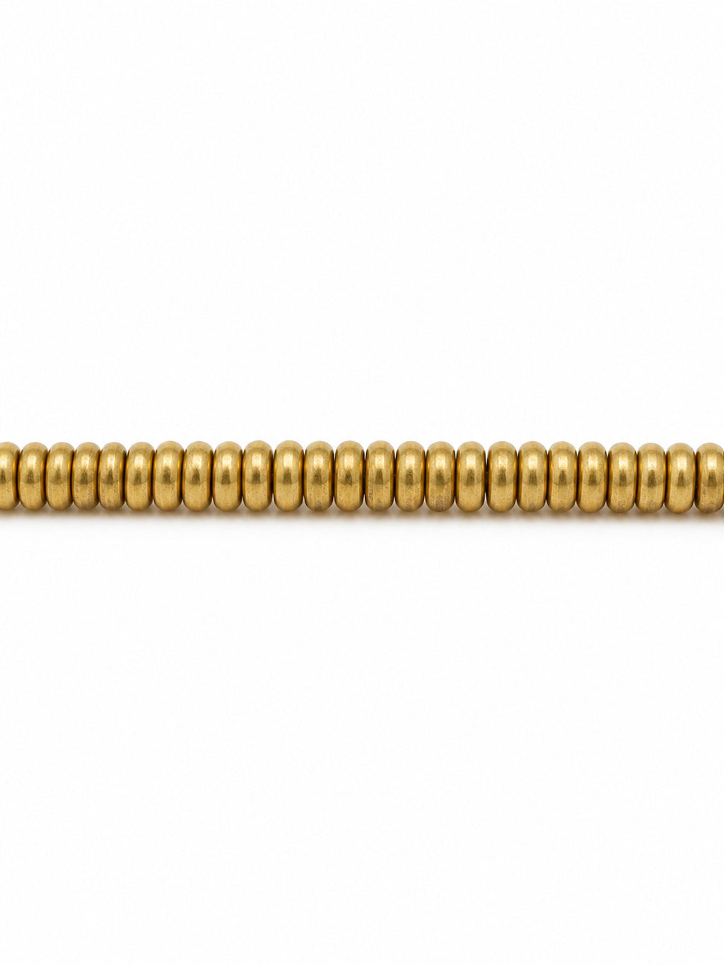 Gold donut beads on white background