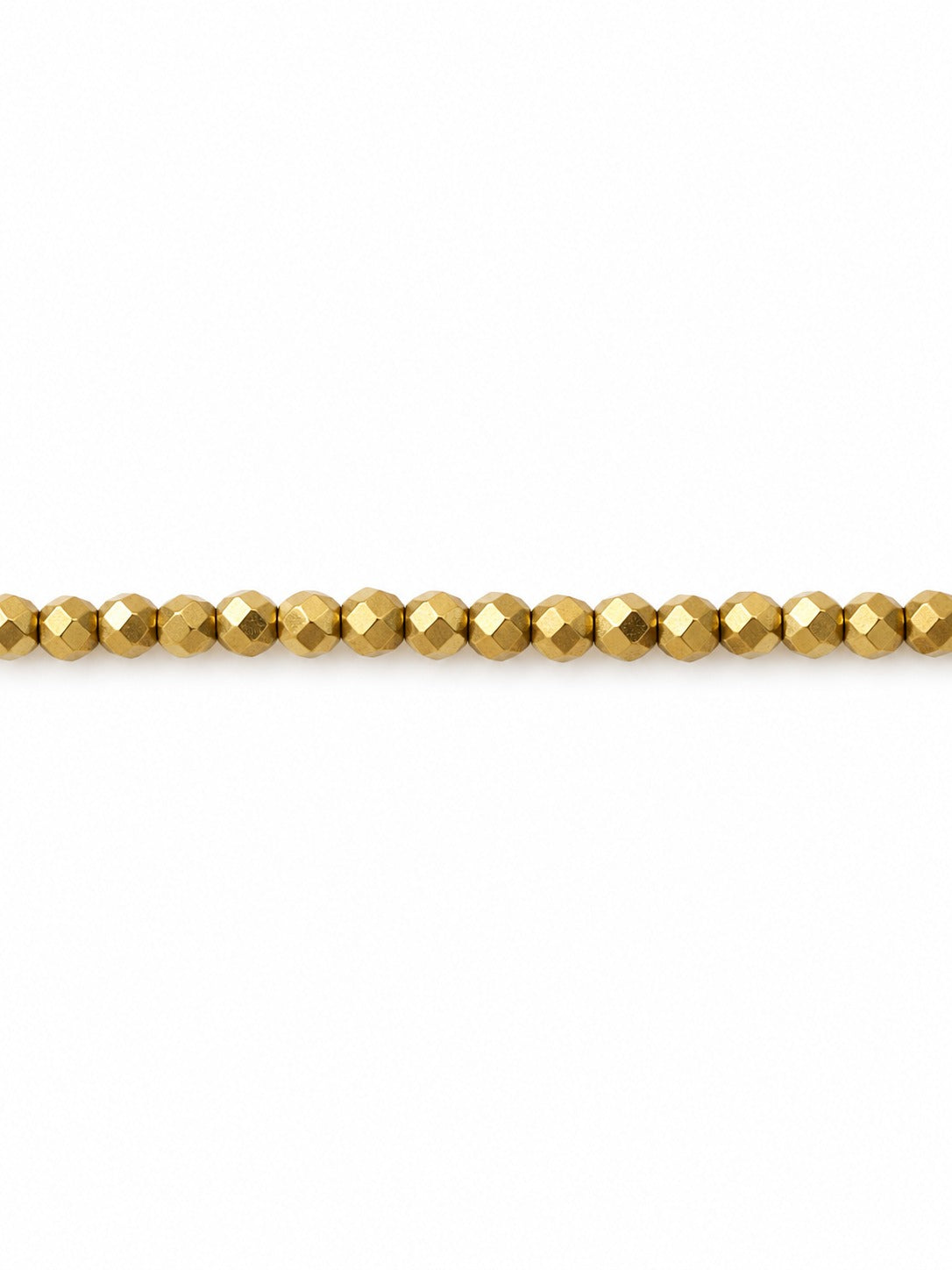 Gold faceted geo beads on white background