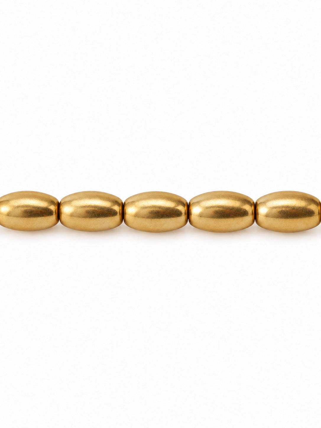 Gold oval beads on white background