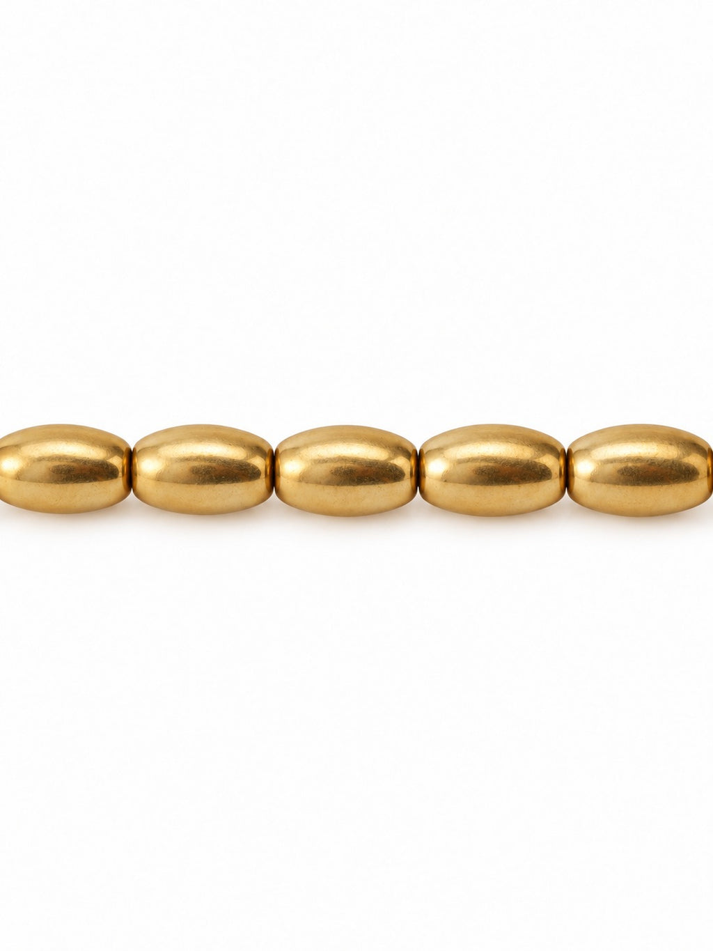 Gold oval beads on white background