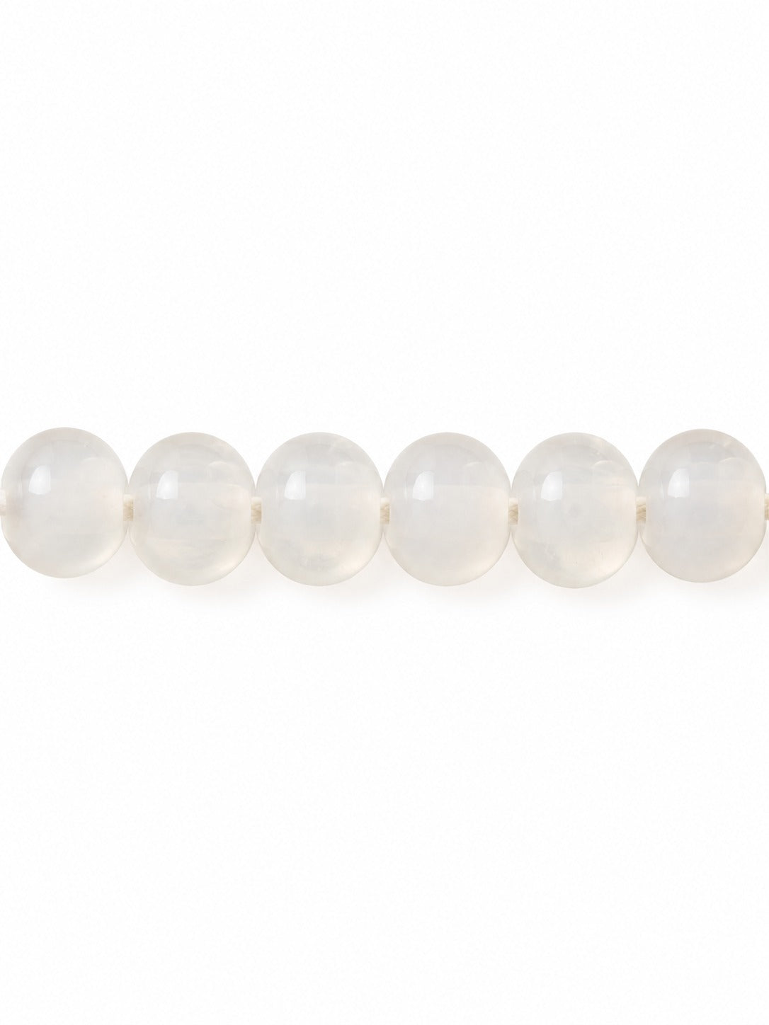 Milky handblown glass beads on white background