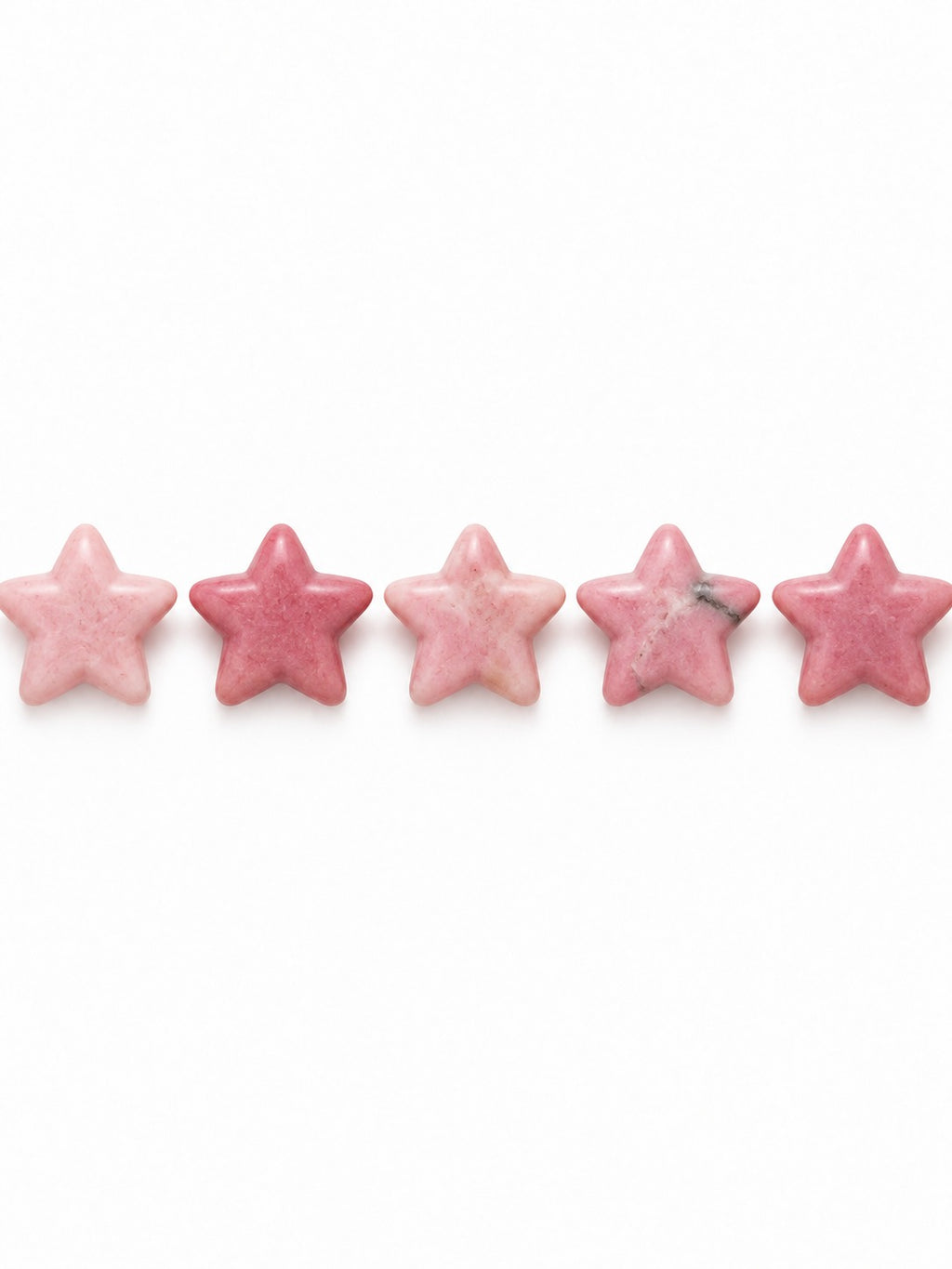 Rhodonite star beads on white background