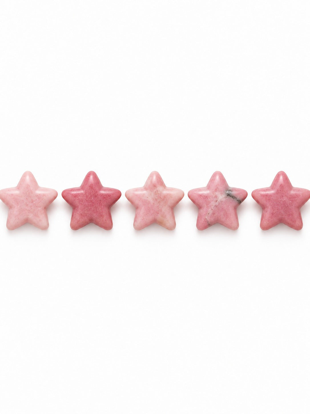 Rhodonite star beads on white background
