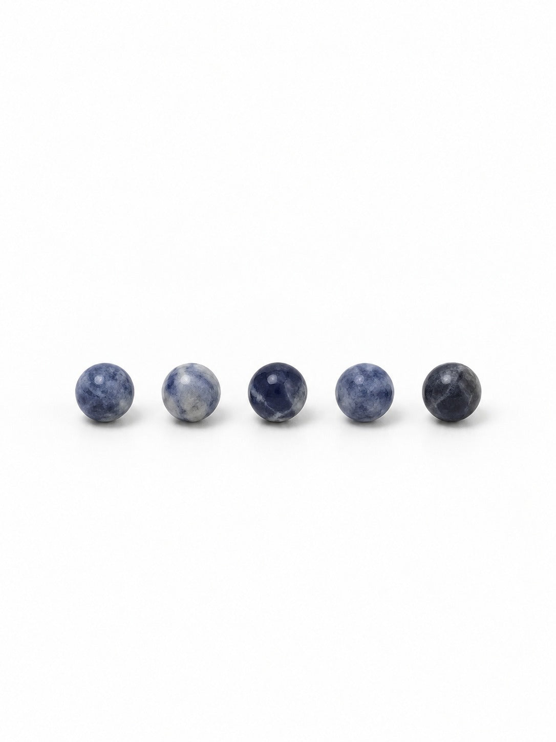 Sodalite round beads on white background
